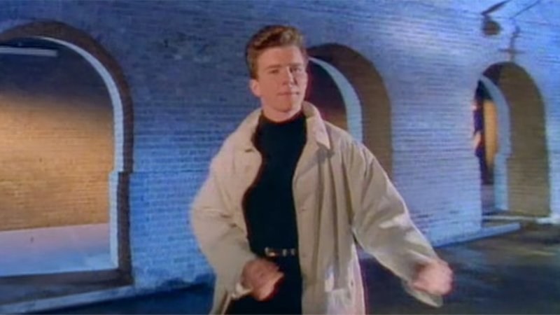 Rickroll | Screen grab or Rick Aston in his Never Gonna Give You Up video, with distinct attire from the mid 80s